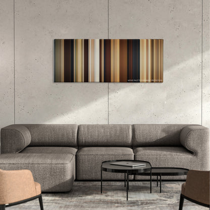 Year One color palette canvas on a concrete wall above a gray sectional sofa
