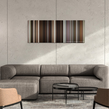 Collateral Beauty color palette canvas on a concrete wall above a gray sectional sofa