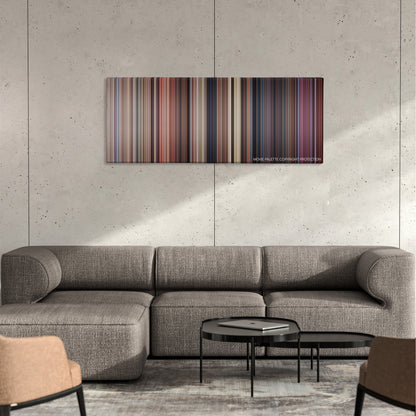Dead Alive color palette canvas on a concrete wall above a gray sectional sofa