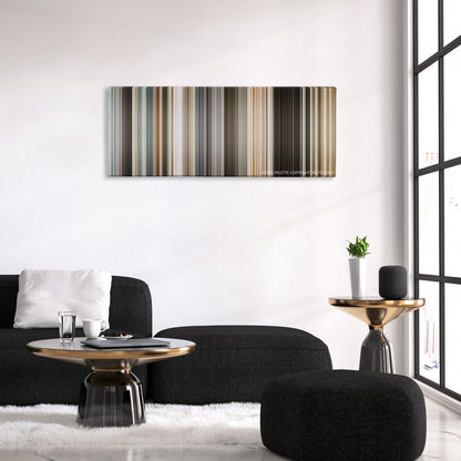 The International color palette canvas above a black sofa with a gold-topped table
