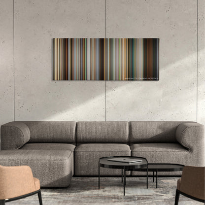The Girl Who Played with Fire color palette canvas on a concrete wall above a gray sectional sofa