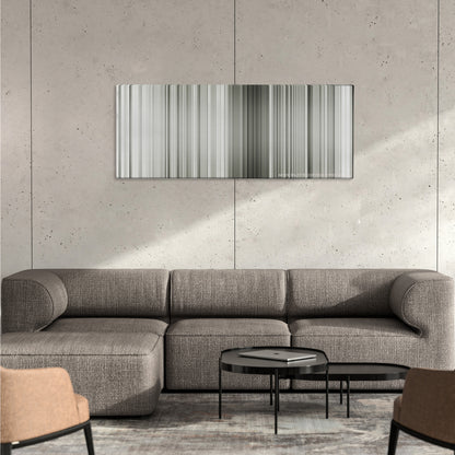 The Great Dictator color palette canvas on a concrete wall above a gray sectional sofa