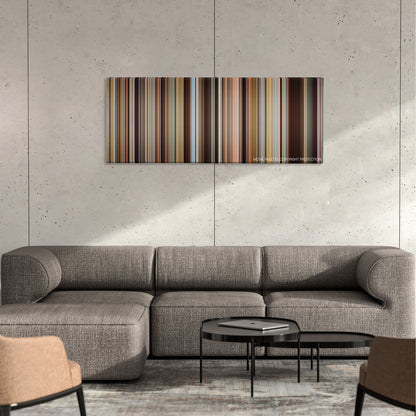 Demolition color palette canvas on a concrete wall above a gray sectional sofa