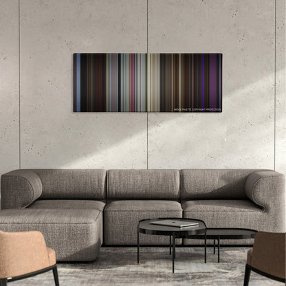 The King of Comedy color palette canvas on a concrete wall above a gray sectional sofa