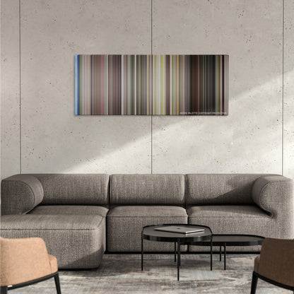 The Happening color palette canvas on a concrete wall above a gray sectional sofa