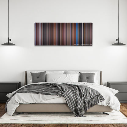 Scrooged color palette canvas above a bed, between two black pendant lamps