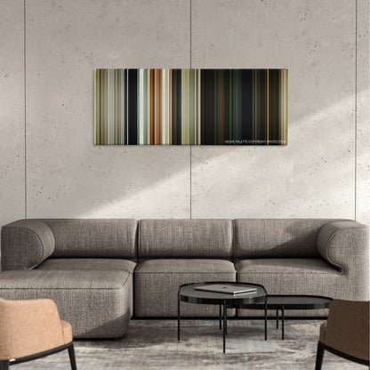 Gemini Man color palette canvas on a concrete wall above a gray sectional sofa