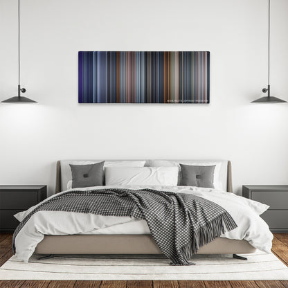 The One color palette canvas above a bed, between two black pendant lamps