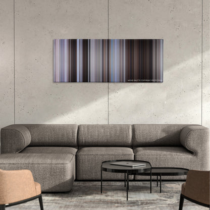 The Magnificent Seven color palette canvas on a concrete wall above a gray sectional sofa
