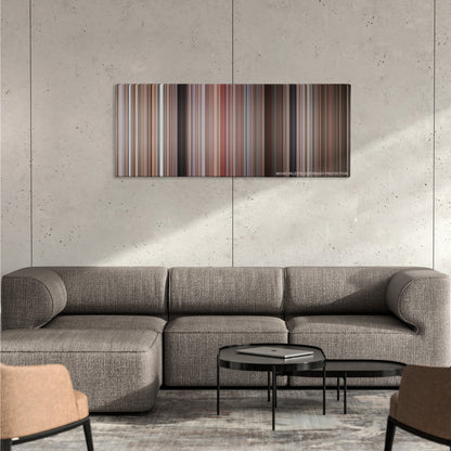 Misery color palette canvas on a concrete wall above a gray sectional sofa