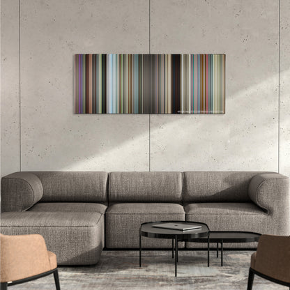 Ted 2 color palette canvas on a concrete wall above a gray sectional sofa