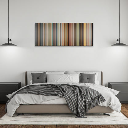Crank color palette canvas above a bed, between two black pendant lamps
