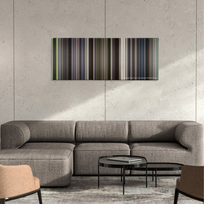 Witness color palette canvas on a concrete wall above a gray sectional sofa