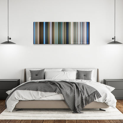 Skyline color palette canvas above a bed, between two black pendant lamps
