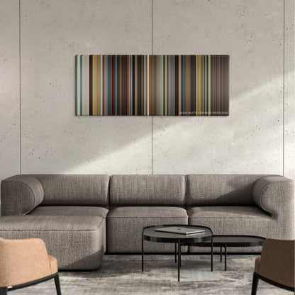Big Eyes color palette canvas on a concrete wall above a gray sectional sofa