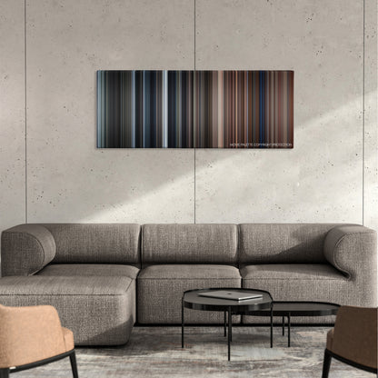 Here Comes the Boom color palette canvas on a concrete wall above a gray sectional sofa