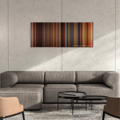 The Quick and the Dead color palette canvas on a concrete wall above a gray sectional sofa