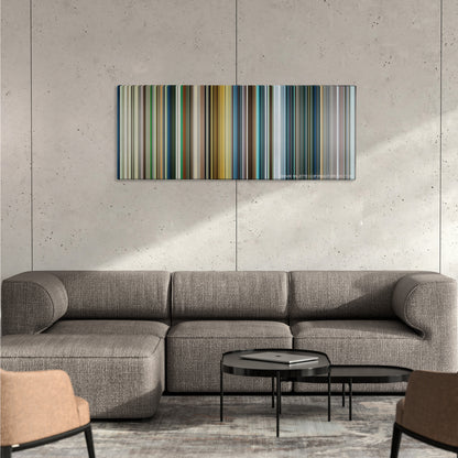 War Dogs color palette canvas on a concrete wall above a gray sectional sofa