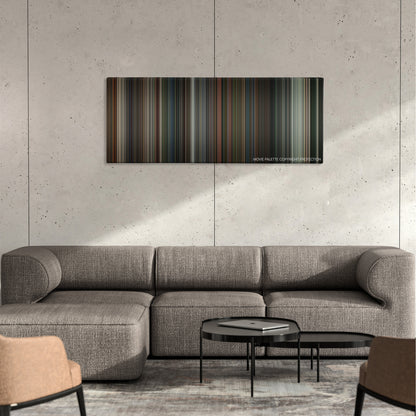 War color palette canvas on a concrete wall above a gray sectional sofa
