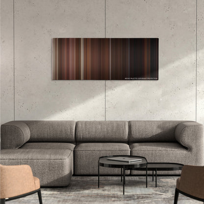 The Man from Earth color palette canvas on a concrete wall above a gray sectional sofa