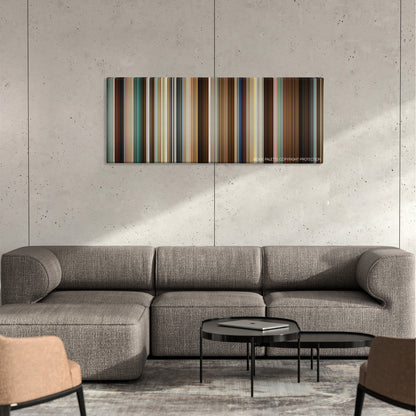 Half Nelson color palette canvas on a concrete wall above a gray sectional sofa
