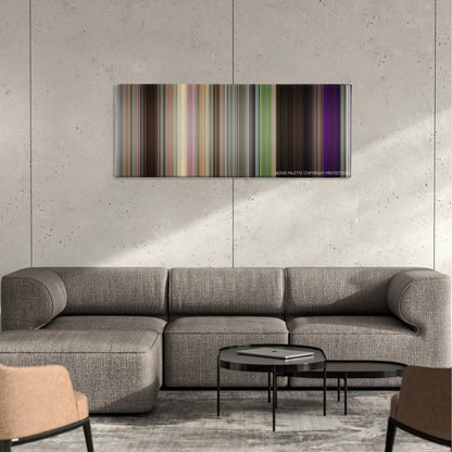 The DUFF color palette canvas on a concrete wall above a gray sectional sofa