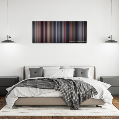 Videodrome color palette canvas above a bed, between two black pendant lamps