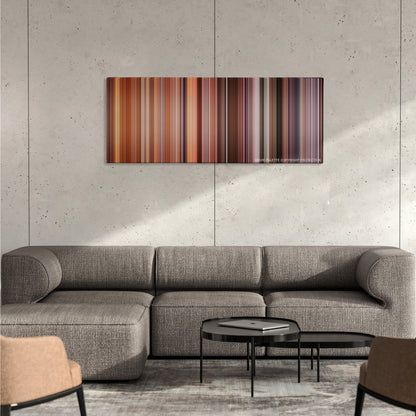 Falling Down color palette canvas on a concrete wall above a gray sectional sofa