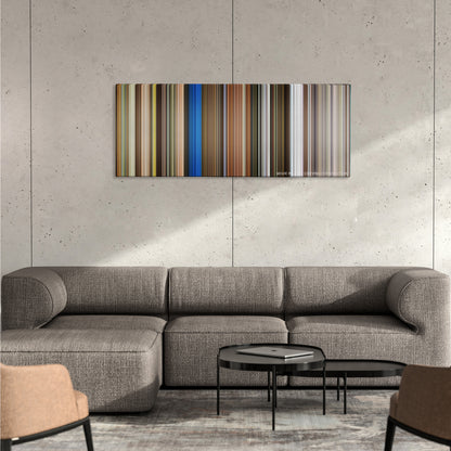xXx color palette canvas on a concrete wall above a gray sectional sofa