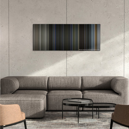 Bright color palette canvas on a concrete wall above a gray sectional sofa