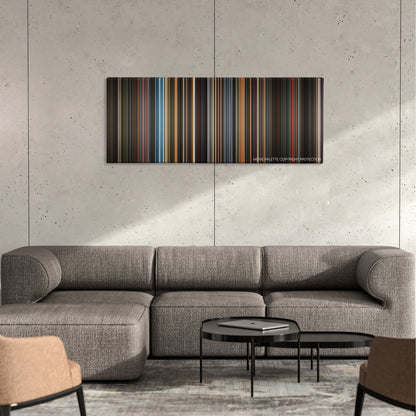 Confessions of a Dangerous Mind color palette canvas on a concrete wall above a gray sectional sofa