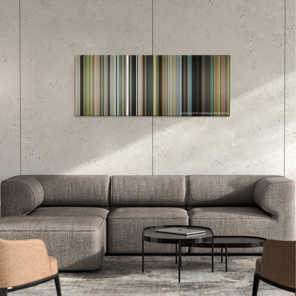 Our Idiot Brother color palette canvas on a concrete wall above a gray sectional sofa