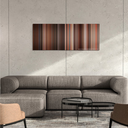 Desperado color palette canvas on a concrete wall above a gray sectional sofa