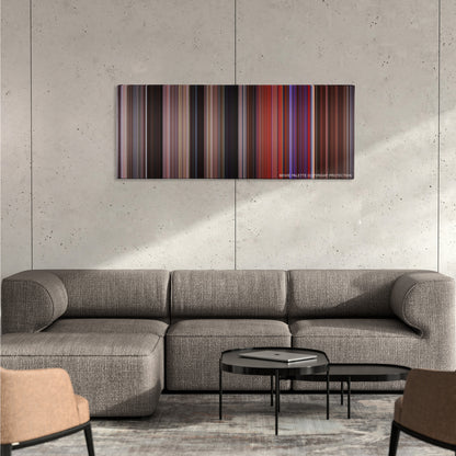 Carrie color palette canvas on a concrete wall above a gray sectional sofa