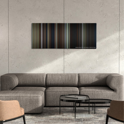 Pet Sematary color palette canvas on a concrete wall above a gray sectional sofa