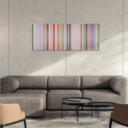 PK color palette canvas on a concrete wall above a gray sectional sofa