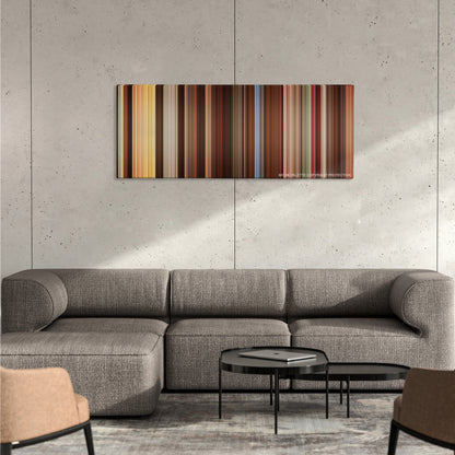 Alexander color palette canvas on a concrete wall above a gray sectional sofa