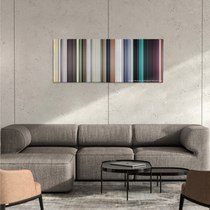 Central Intelligence color palette canvas on a concrete wall above a gray sectional sofa