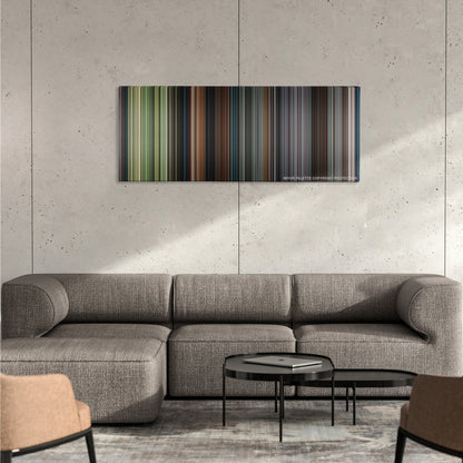 Steve Jobs color palette canvas on a concrete wall above a gray sectional sofa