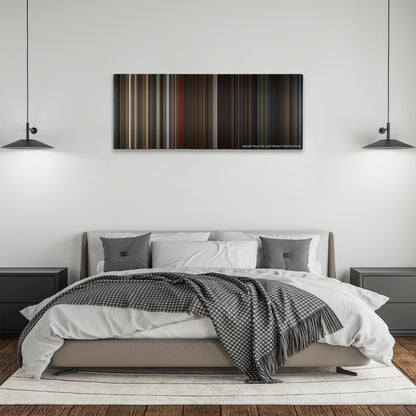 Darkest Hour color palette canvas above a bed, between two black pendant lamps