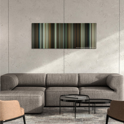 Michael Clayton color palette canvas on a concrete wall above a gray sectional sofa
