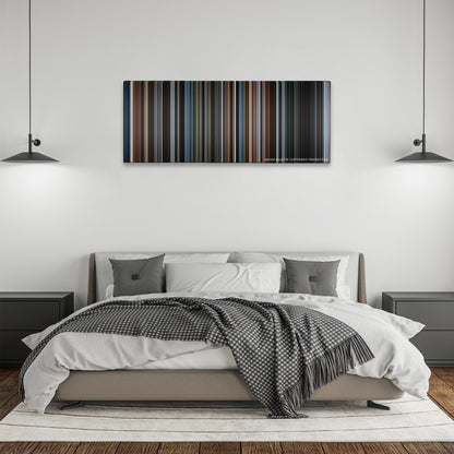 First Man color palette canvas above a bed, between two black pendant lamps