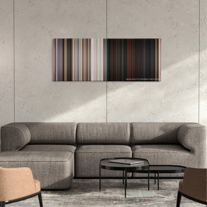 No Escape color palette canvas on a concrete wall above a gray sectional sofa