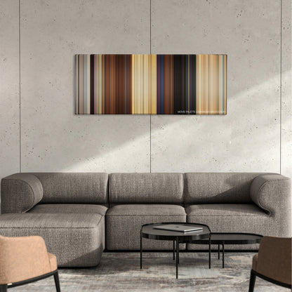 The Inbetweeners color palette canvas on a concrete wall above a gray sectional sofa
