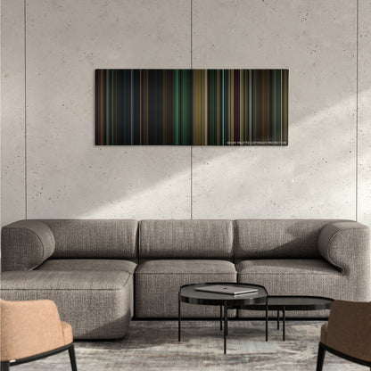 Buried color palette canvas on a concrete wall above a gray sectional sofa