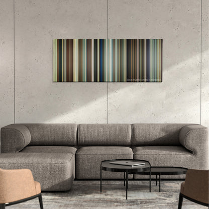 You, Me and Dupree color palette canvas on a concrete wall above a gray sectional sofa