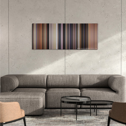 Johnny English color palette canvas on a concrete wall above a gray sectional sofa