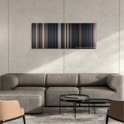 Frailty color palette canvas on a concrete wall above a gray sectional sofa