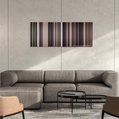 Network color palette canvas on a concrete wall above a gray sectional sofa