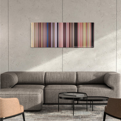She's the Man color palette canvas on a concrete wall above a gray sectional sofa
